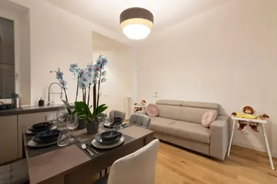 a living room with a table and a couch at A Casa Tua Vatican Suite in Rome