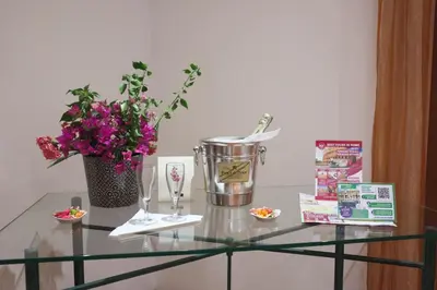 a glass table with a vase and flowers on it at Residenza in Vaticano Roma in Rome