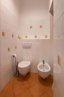 a white bathroom with a toilet and a bidet at Residenza in Vaticano Roma in Rome