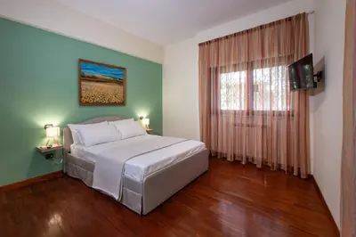 a bedroom with a large white bed and a window at Residenza in Vaticano Roma in Rome