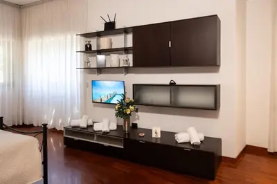 a living room with a tv on a wall at Residenza in Vaticano Roma in Rome