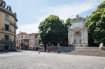 a monument in the middle of a street at Number Five Apartment in Trastevere in Rome