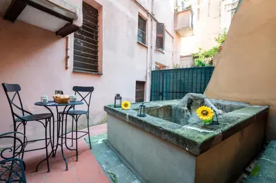 a concrete tub with a table and chairs on a patio at Number Five Apartment in Trastevere in Rome