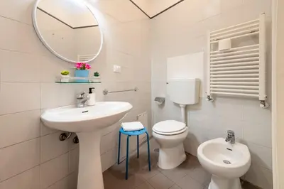 a bathroom with a sink and a toilet and a mirror at Number Five Apartment in Trastevere in Rome