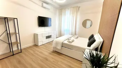 a white room with a bed and a tv at LH Vatican Museum Wi-Fi AC Flat Premium Comfort in Rome