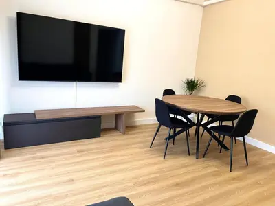 a conference room with a table and a flat screen tv at LH Vatican Museum Wi-Fi AC Flat Premium Comfort in Rome