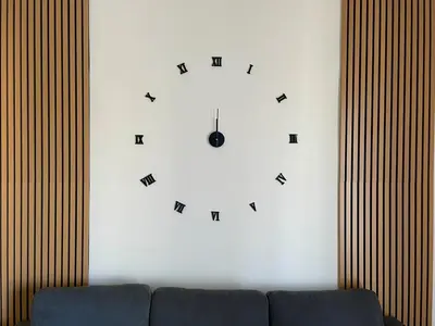 a clock on a white wall with a couch at LH Vatican Museum Wi-Fi AC Flat Premium Comfort in Rome