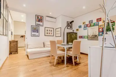a living room with a table and chairs and a couch at Green Loft di Trastevere in Rome
