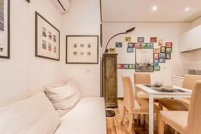 a living room with a couch and a table at Green Loft di Trastevere in Rome