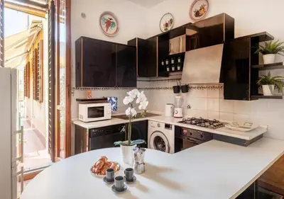 a kitchen with a white counter top and a stove at Luxury in Rome Panoramic terrace Fontana di Trevi in Rome