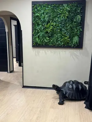 a black purse laying on the floor in front of a green wall at Marconi Suite & Charme in Rome