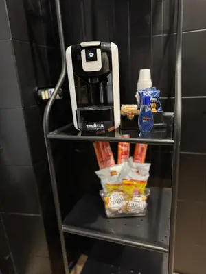 a coffee maker sitting on a shelf with food at Marconi Suite & Charme in Rome