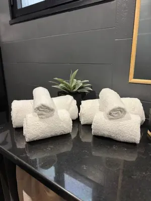 four towels sitting on a counter in a bathroom at Marconi Suite & Charme in Rome