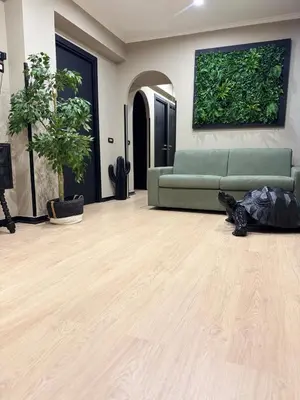 a living room with a green couch and a wooden floor at Marconi Suite & Charme in Rome