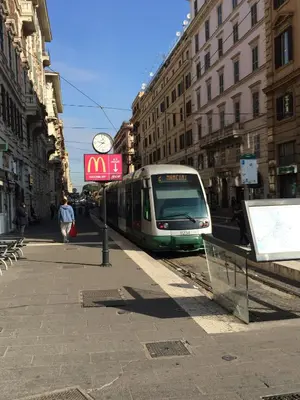 a train is on the tracks in a city at Relais Piazza Del Popolo in Rome