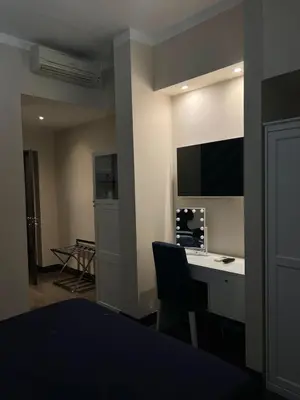a room with a desk and a tv on a wall at Relais Piazza Del Popolo in Rome