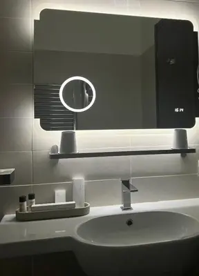 a bathroom sink with a large mirror above it at Relais Piazza Del Popolo in Rome