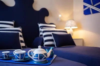 a room with two beds and a tray with tea cups at Relais Piazza Del Popolo in Rome