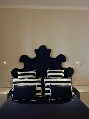 a bedroom with a black and white bed with pillows at Relais Piazza Del Popolo in Rome