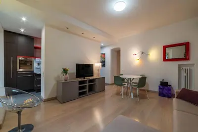 a living room with a couch and a table with chairs at Leone IV - WelcomeToRhome in Rome