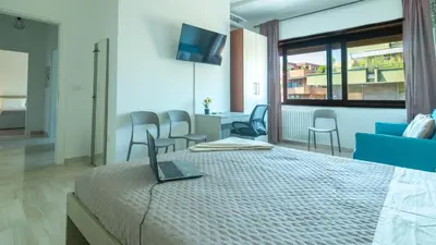 a bedroom with a bed with a laptop on it at Casa vacanza Appartamento Irnerio vicino la Metro in Rome