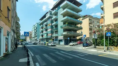 a city street with cars parked on the side of a building at Casa vacanza Appartamento Irnerio vicino la Metro in Rome