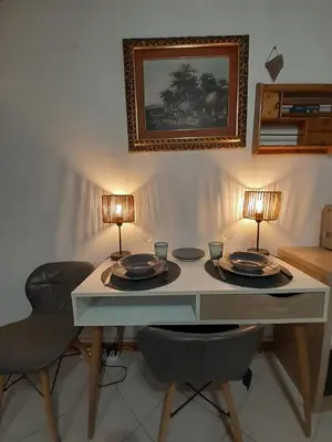 a dining room table with two lamps and two chairs at Loft Lomelina, Roma, Metro Bologna Colosseo in Rome