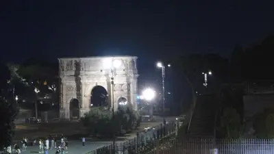 a building at night with people walking in front of it at Loft Lomelina, Roma, Metro Bologna Colosseo in Rome