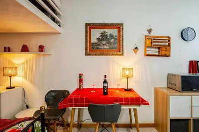 a dining room with a table with two bottles of wine at Loft Lomelina, Roma, Metro Bologna Colosseo in Rome