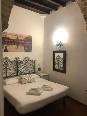 a bedroom with a bed with towels on it at Appartamento Castel Sant'Angelo in Rome