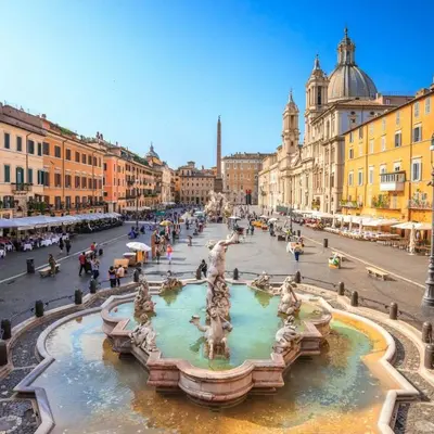 a street with a fountain in the middle of a city at Appartamento Castel Sant'Angelo in Rome