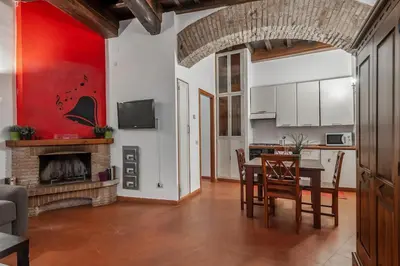 a living room with a table and a fireplace at Appartamento Castel Sant'Angelo in Rome