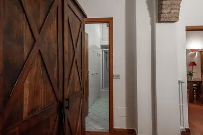 a sliding barn door in a room with a bathroom at Appartamento Castel Sant'Angelo in Rome