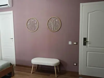 a room with a chair and two plates on the wall at Gloria Mundi in Rome