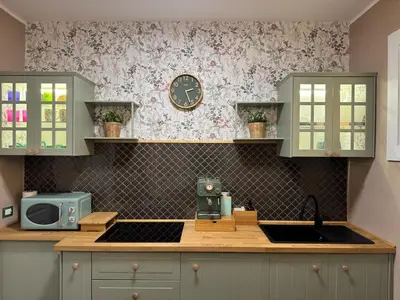 a kitchen with a sink and a clock on the wall at Gloria Mundi in Rome