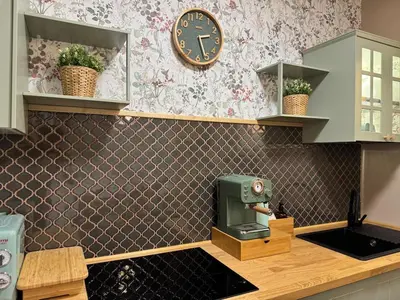 a kitchen with a sink and a clock on the wall at Gloria Mundi in Rome