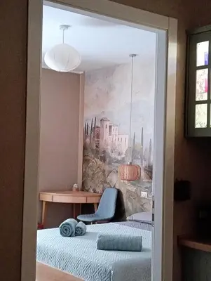a bedroom with a painting on the wall and a chair at Gloria Mundi in Rome