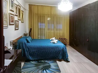 a bedroom with a blue bed with towels on it at The Pope's Room in Rome