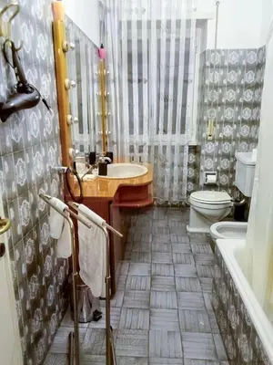a bathroom with a sink and a toilet and a tub at The Pope's Room in Rome