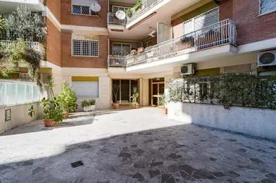 an empty courtyard of a building with plants at The Pope's Room in Rome