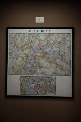 a framed picture of a map on a wall at Sunset Home in Rome