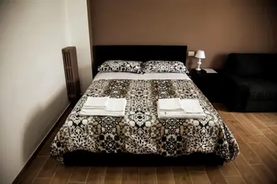 a bedroom with a bed and a couch at Sunset Home in Rome