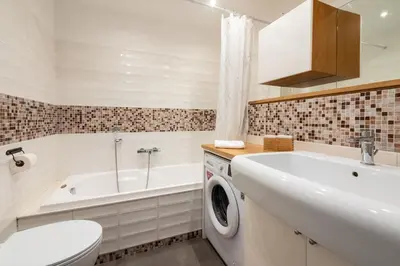 a bathroom with a sink and a washing machine at Angelina Domus Saint Peter's in Rome