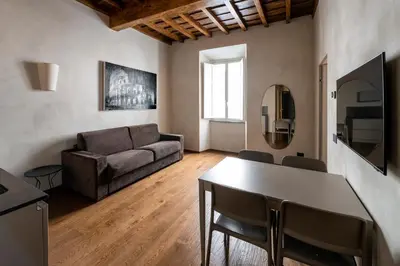 a living room with a couch and a table at Roma apartments in Rome