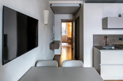 a dining room with a white table and chairs at Roma apartments in Rome