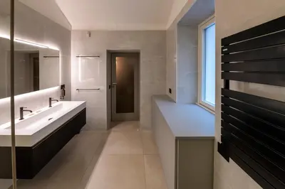 a bathroom with a sink and a large mirror at Roma apartments in Rome