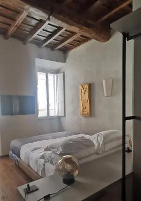 a bedroom with a large bed and a window at Roma apartments in Rome