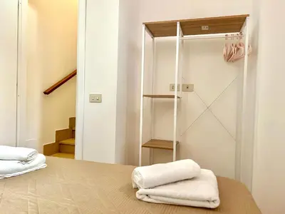 a bedroom with a bed with two towels on it at Linda Charme in Rome