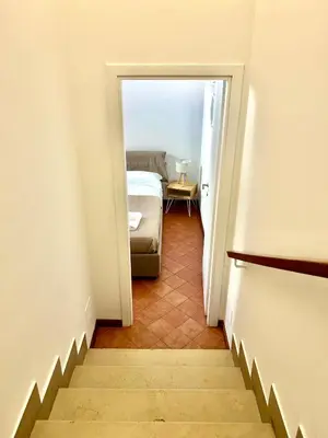 a stairway leading to a bedroom with a bed at Linda Charme in Rome