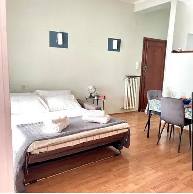 a bedroom with a bed and a table and chairs at K-Vatican Apartment in Rome